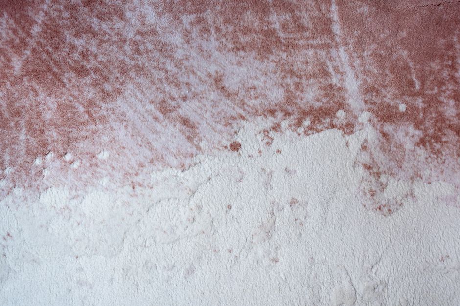Close-up of white textured ceiling paint with a stippled Artex-style pattern